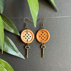 Found object earrings in a brass tone with wood buttons. Object Earrings, Button Keychain, Wood Buttons, Button Jewelry, Button Earrings, Found Object, Hand Made Jewelry, Jewelry Earrings Dangle, Etsy Earrings