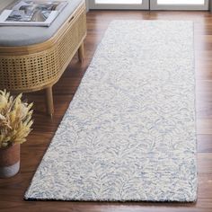 a large white rug on top of a wooden floor