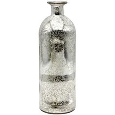 a glass bottle filled with lots of white sand and silver flecks sitting on top of a table