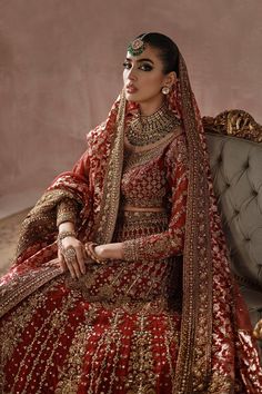 Classic Red Gold Heavily Embellished Pakistani Bridal Dress Lehenga Choli is worked in very fine Zardozi and fine gold crystals and sequins with a beautiful, traditional zari net dupatta in light red with fully embellished borders. This grand piece is more gorgeous each time. Detailed Description: SKU: BB319 Detailing: Embroidery, Motifs, Naqshi, Sequins, Dabka, Zari, Tilla, Adda work Color: Red and Gold Fabric: Jamawar, Tissue, Crimson Chiffon Design: Fully Embellished Dress with Embroidery Event: Bridal wear, Wedding Pakistani Bridal Lehenga, Dress Lehenga, Pakistani Lehenga, Pakistani Bridal Dress, Gold Crystals, Pakistani Bridal Dresses, Bridal Lehenga Choli, Pakistani Bridal Wear, Net Dupatta