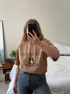 "MEASUREMENTS AND ALL AVAILABLE SIZING INFO IS LISTED FOR EVERY ITEM. Please read this section in detail and reach out with any additional questions:) Vintage oversized tan Ocracoke Island tshirt. This shirt is soft and comfy due to prelove wear. she is in great condition with no noticed physical marks, just some light fabric fade. Tag reads Murina - size XL (men's) - Made in USA - 100% cotton  Recommended for sizes xs-xl depending on desired fit. Model is a size medium-large. Approximate flat lay measurements are as follows:  22\" shoulder to shoulder  23\" underarm to underarm  30.5\"  top of shoulder shoulder to hemline. There is always a possibility of minor flaws in vintage items due to pre-love wear. We will always do our best to mention them in the description above but if you have Retro Beige Crew Neck T-shirt, Beige Retro Crew Neck T-shirt, Retro Beige Short Sleeve T-shirt, Oversized Vintage Print Graphic Tee, Vintage Brown Crew Neck Top, Vintage Brown Tops With Text Print, Vintage Brown Top With Text Print, Vintage Oversized Crew Neck T-shirt, Retro Beige Cotton T-shirt