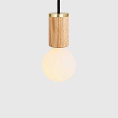 a light that is on top of a wooden pole and has a black cord attached to it