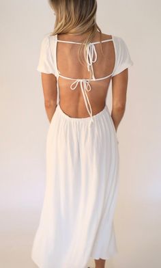 the back of a woman wearing a white dress