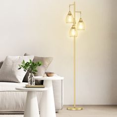 a living room scene with focus on the floor lamp and table in front of the couch