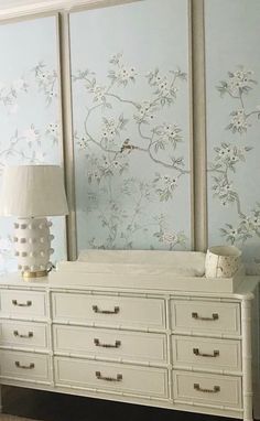 a white dresser sitting next to a baby crib