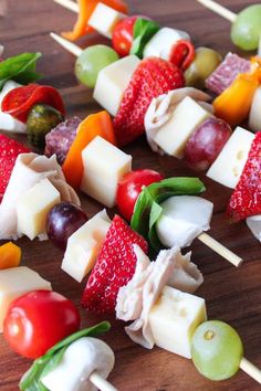 fruit and cheese skewers on a wooden table