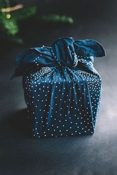 a blue wrapped present with white dots on it