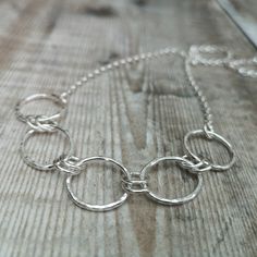 This lovely statement necklace is made from 5 larger links, in 2 different shapes, ovals and circles, and 8 smaller circle links. The larger links all have a hammered finish and the smaller links have a smooth finish. The necklace is finished with a Sterling Silver cable chain, the overall length of the necklace is approximately 18 inches. PLEASE NOTE: This necklace is made to order. Postage & Packaging: Shipping is free for all UK orders and will be sent via 1st Class Post unless otherwise Silver Link Necklace, Chain Necklace Silver, Silver Star Earrings, Necklace Chunky, Silver Chain Style, Sterling Silver Chain Necklace, Small Earrings Studs, Moon Jewelry, Geometric Jewelry