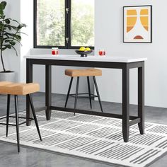 a kitchen table with two stools next to it