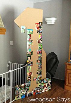 a cardboard tower with pictures on it and a chair in the corner next to it