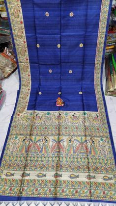 This soft Madhubani Rich Madhubani art work all over the saree, this saree contained superior Tassar or tussar Silk body with Matka Blouse piece.And the unique design are made by master Craftman(More then 10 year experience) comes with wave depict(Mithila pattern)all over the saree and this Madhubani saree comes with blouse piece. The saree is very soft in nature .You can wear any kind of occasions purposes. Madhubani: Madhubani arts began in the Mithila.The Mithila art on Madhubani painted sare Blue Kalamkari Print Saree For Festivals, Bohemian Tussar Silk Traditional Wear For Navratri, Blue Art Silk Traditional Wear With Kalamkari Print, Blue Katan Silk Dupatta With Kalamkari Print, Navratri Bohemian Dola Silk Saree, Bohemian Katan Silk Traditional Wear For Festivals, Blue Art Silk Dupatta With Kalamkari Print, Navratri Slub Silk Blouse Piece With Motifs, Kalamkari Print Lehenga For Puja And Festivals