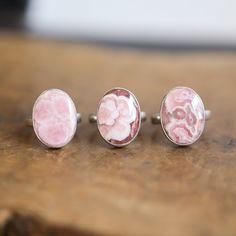 There are 3, beautiful,  Ready to Ship Rhodochrosite Sterling Silver Rings in this listing - sizes 6, 7, and 8. You Choose ONE Ring from the dropdown - your ring will be highlighted in the photo as you choose. Stunning and unique patterns in this gorgeous Rhodochrosite. Choose your ring from these 3 high-end, gorgeously patterned pink Rhodochrosite Sterling Silver rings. This listing is for One Ring Only. Sizes can be bumped up a half size at no extra charge. Large Oval of High-grade Deeply hued Rhodochrosite Ring, Silversmith Rings, Boho Statement Ring, Kyanite Earrings, Pink Rhodochrosite, Jasper Ring, Tourmaline Earrings, Big Rings, Boho Pendant