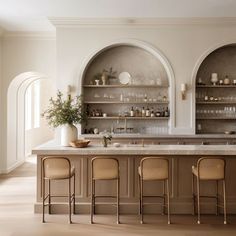 an elegant kitchen with marble counter tops and bar stools