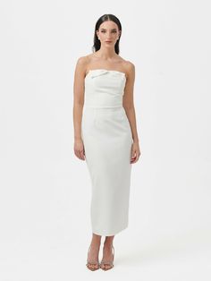 Introducing the Barbi Bow Midi Dress, a delightful blend of sophistication and charm. With its strapless design and pencil shape midi skirt, this dress becomes classic elegance and timeless. The bow front detail adds a playful and feminine touch, enhancing its overall appeal. Features a discreet zip on the back, strapless neckline and midi lenght. Strapless Neckline, Classic Elegance, Midi Skirt, Overalls, Midi Dress, Pencil, Skirt, Design