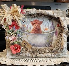 an altered photograph of a cow in a bathtub with flowers on the side and ribbons around it