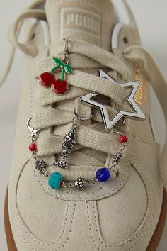 Add a little something special to your shoe game with this set of charms featuring dangly details, drapey chains, and defined pins for the perfect finishing touch. | Shoe Charm & Pin Pack by Free People in Red Shoe Clips Sneakers, Bubble Shoes Charms, Unique Accessories Fashion, Charms On Shoes, Samba Charms, Shoe Charms Diy, Shoe Lace Charms, Sneaker Charms, Interesting Accessories