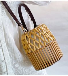 Unlock your inner elegance with the Elena Handbags Summer Bamboo Bucket Shoulder Purse. Expertly hand-woven from quality bamboo, this luxury Bucket Bag is the perfect accessory for any stylish occasion, from the office to a formal event. With its timeless design, it's sure to become your new favorite. Enjoy maximum convenience and beautiful aesthetics with this exquisite bag. Size: 18cm tall x 15cm wide (7in x 6in) Designer Style ID: 8476 Women's Bamboo Bucket Bag, Hand Woven Bucket Bag, Fashion Sustainable Bag, Bamboo Bag, Bohemian Bags, Crochet Clutch, Woman Weaving, Luxury Designer Handbags, Designer Style, Woven Bag, Shoulder Purse