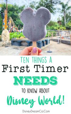 a hand holding up a mickey mouse lollipop with the words ten things a first timer needs to know about disney world