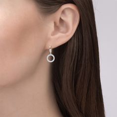 Crafted in sterling silver, each earring showcases a doughnut-like circle set with glistening small stones and linked in a dangling style. A smart choice for both day and night, these drop earrings fit any occasion and draw all the right kinds of attention. Polished to a bright shine, this chic pair of earrings is sure to be your contemporary classic.  Carat Weight: 1.28 ctStone Size: 1 mmStone Type: Jeulia® StoneNumber of Stones: 128 Stone Shape: RoundStone Color: Diamond WhiteWeight: 3.75 gWid Diamond White Sparkling Stones Hoop Earrings, Elegant Round Halo Earrings, Everyday Cubic Zirconia Halo Diamond Earrings, Diamond White Halo Jewelry, Modern Small Hoop Jewelry With Diamond Accents, Modern Gold Earrings With Sparkling Stones, Small Hoop Cubic Zirconia Jewelry With Halo Design, Everyday White Gold Drop Earrings, Round Diamond Earrings With Sparkling Stones