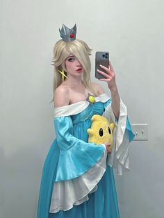 a woman dressed as a princess holding a cell phone