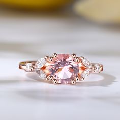 Indulge in the ethereal beauty of the morganite ring, a stunning masterpiece that captures hearts and captivates souls. Crafted with a captivating round-cut morganite as its centerpiece, this ring exudes timeless beauty. The delicate blush hue of the morganite is complemented by the dazzling brilliance of the marquise-cut white stones that gracefully adorn its sides. Embrace the allure of this enchanting piece, where the soft pink hues of the morganite symbolize love and compassion, while the sp Luxury Morganite Round Ring, Luxury Round Morganite Rings, Luxury Pink Morganite Jewelry, Elegant Morganite Diamond Ring With Gemstone, Luxury Pink Topaz Round Ring, Exquisite Morganite Rose Gold Rings, Fine Jewelry Morganite Diamond Ring In Rose Gold, Luxury Morganite Diamond Ring Gift, Luxury Morganite Diamond Ring As Gift