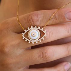 Step into the realm of modern mystique with our unique White Evil Eye necklace, a fresh interpretation of the classic protective symbol. Meticulously crafted from premium 925 sterling silver, this necklace features a serene white eye surrounded by artificial zircon stones, offering a touch of elegance and positivity. Key Features: Contemporary Evil Eye Design: Departing from the traditional blue, our White Evil Eye necklace introduces a serene white eye as a symbol of purity and protection. The eye is surrounded by meticulously set artificial zircon stones, adding a luxurious touch to the classic evil eye motif. Premium 925 Sterling Silver: Elevate your jewelry collection with our high-quality sterling silver necklace. The durable and timeless material serves as the perfect canvas for the White Evil Eye, Protective Charms, Evil Eye Design, Silver Eye, Evil Eye Necklace, Evil Eye Jewelry, Girly Jewelry, Eye Jewelry, Eye Necklace