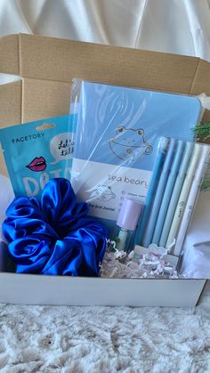 a box filled with blue items on top of a bed