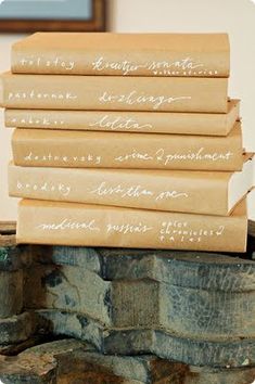 five brown paper bags with writing on them stacked up in front of each other,