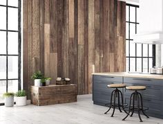 a kitchen with wood paneling and two stools