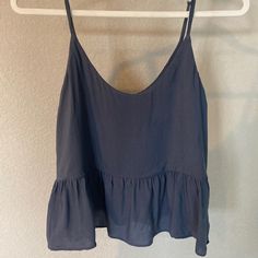 Greyish Blue Crop Top With Ruffle Detail. Adjustable Straps, Size 4 Blue Ruffled Cami Tank Top, Blue Ruffled Top With Spaghetti Straps, Blue Spaghetti Strap Top With Ruffles, Blue Ruffled Spaghetti Strap Top, Blue Cami Camisole For Day Out, Blue Camisole For Day Out, Vacation Blue Ruffled Tank Top, Blue Spaghetti Strap Camisole For Day Out, Babydoll Tank Top