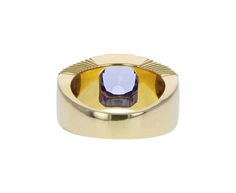 Striking in its intense color and modern design, this Retrouvai ring has a breathtaking presence. The rectangular blue-lavender tanzanite is set vertically and bezel set within the tiered 14K yellow gold polished band. Wear it as a statement making alternative to the traditional cocktail ring. It is a modern classic. tanzanite : 7.5mm x 7mm : 2.41ct14K yellow gold band width : 5mm to 9mmsize available : 6.5please contact us for sizing options Modern Oval Tanzanite Sapphire Ring, Formal Tanzanite Ring With Bezel Setting, Modern Yellow Gold Sapphire Ring For Formal Events, Modern Yellow Gold Sapphire Ring For Formal Occasions, Modern Yellow Gold Tanzanite Jewelry, Modern Oval Tanzanite Ring, Modern Yellow Gold Amethyst Ring For Formal Occasions, Modern Tanzanite Rings, Modern Amethyst Ring With Bezel Setting