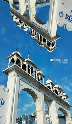 two white arches with blue sky in the background