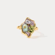 Elevate your jewelry collection with the enchanting allure of our Purple Pearl Tulip Flower Ring. This exquisite piece captures the delicate beauty of nature with its intricately crafted tulip flower design, accentuated by lustrous pearls set against a backdrop of rich, deep purple enamel. Crafted from 18K gold-plated brass, this ring exudes luxury and sophistication, making it a timeless accessory that adds a touch of elegance to any ensemble. Its unique design and vibrant color palette make it Delicate Gold Flower Ring With Gemstone, Elegant Birth Flower Ring, Gold Flower Ring Nature-inspired, Elegant Gold Enamel Flower Ring, Gold Flower-shaped Nature-inspired Rings, Elegant Flower Enamel Ring For Wedding, Elegant Floral Enamel Ring For Wedding, Gold Nature-inspired Flower Ring, Elegant Flower-shaped Enamel Wedding Ring