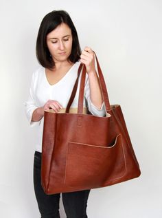 "Cognac brown leather tote - large leather tote bag This brown large tote bag is made from high quality italian leather. Spacious interior provides room for all the daily essentials and more. There is an inside zippered pocket. This bag is perfect as your everyday bag, which can fit an IPAD, A4 files, books, magazines, cosmetic bag as well as many accessories. Additional large slip pocket at the front of the bag. Height: 39 cm / 15.4\" Max width at the top: 61 cm / 24\" Width at the base: 51 cm Full Grain Leather Bag, Extra Large Tote Bags, Tote Bag With Pockets, Slouchy Tote, Leather Weekender, Large Leather Tote Bag, Soft Leather Bag, Oversized Tote Bag, Oversized Bag