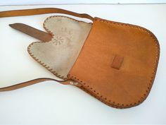 Vintage Genuine leather bag - Bag Of Genuine Calfskin - Retro leather bag - Old leather bag from 70'- leather bag - Genuine Leather handbag Used in good vintage condition . For people who love items with history . Dimensions : Height without the handle - 20 cm x 21 cm For other VINTAGE BAG OF GENUINE LEATHER please check here : https://www.etsy.com/shop/TheVINTAGEShopBG/items?section_id=22456024 All pictures are real . You buy exactly what you see in the photos . Thank you for visiting my store. Medium Leather Satchel, Handmade Leather Saddle Bag Pouch, Handmade Leather Pouch Saddle Bag, Handmade Saddle Shoulder Bag For Travel, Medium Leather Bag With Leather Handles, Medium Leather Satchel For Travel, Medium Leather Shoulder Bag For Travel, Leather Backed Satchel Shoulder Bag As Gift, Leather Backed Satchel Shoulder Bag For Gift