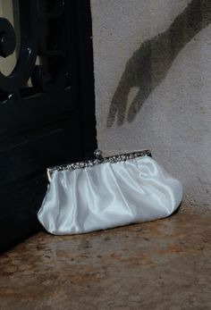 Our Hollywood inspired Satin Glamour Clutch is a perfect addition to your vintage look! Made of luxe satin with a reproduction antique metallic frame and chain, the purse features a satin lining, interior pocket, and optional chain. Measures 5" tall x 10"wide Formal Satin Evening Bag With Satin Lining, Elegant Satin Finish Evening Bag, Elegant Satin Finish Evening Bag For Formal Events, Elegant Satin Finish Evening Bag For Formal Occasions, Elegant Satin Evening Bag For Formal Occasions, Elegant Rectangular Satin Evening Bag, Elegant Satin Rectangular Evening Bag, Elegant Formal Bags With Satin Finish, Elegant Satin Evening Bag With Satin Finish