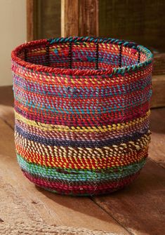 a colorful basket sitting on top of a wooden table