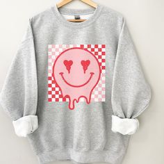 Retro Smiley Face sweatshirt, Distressed Vintage Look Smiley face, Crewneck sweatshirt, Retro smile, smile graphic sweater, valentines, melted smiley face, good vibes, positivity, Be Happy, Brahman Darlin Thank you for shopping my small business. Please message me if you have questions. This is a physical shirt that is made when you order it and shipped out to you. I do not sell my designs, they are made with love, by me to support my family's cattle ranch. If you love the design and would like Funny Graphic Print Sweatshirt For Winter, Trendy Heart Graphic Sweatshirt For Winter, Pink Casual Sweatshirt With Heart Graphic, Trendy Long Sleeve Sweatshirt With Funny Print, Casual Pink Sweatshirt With Heart Graphic, Trendy Winter Sweatshirt With Heart Graphic, Casual Oversized Sweatshirt With Heart Graphic, Trendy Screen Print Sweatshirt For Loungewear, Casual Sweatshirt With Heart Graphic For Loungewear