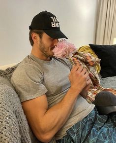 a man sitting on a couch eating something