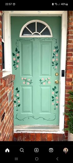 a green door with flowers painted on it