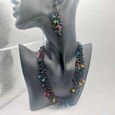 Beautiful set of black beads with Lucite multicolor beads in between very unique and stunning.  Necklace is 6 strands and 16" hook earrings are 2.5" dangle. In excellent condition.  Please see my other listings for more great vintage finds Black Bohemian Jewelry With Faceted Beads, Black Bohemian Earrings With Faceted Beads, Multicolor Dangle Jewelry With Black Beads, Black Bohemian Multi-strand Beads, Bohemian Black Multi-strand Beads, Black Beaded Dangle Earrings With Beaded Chain, Black Beaded Chain Dangle Earrings, Black Bohemian Beaded Earrings With Beaded Chain, Black Dangle Jewelry With Colorful Beads