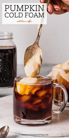 someone spooning ice cream out of a mug filled with pumpkin cold - fudge