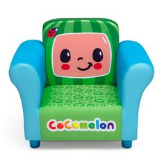 a green and blue children's chair with a cartoon character on the back, sitting in front of a white background