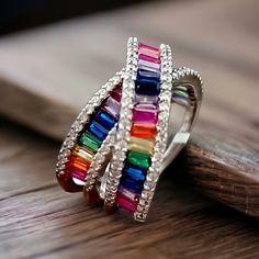 Beautiful In Meaning And Appearance, Rainbows Hold A Special Place In Many Hearts. Crafted In Sterling Silver, This Ring Boasts A Stunning X Crossover Design That Is Lined With Baguette-Shaped Cubic Zirconia Stones In A Rainbow Of Vibrant Colors. The Rainbow Rows Are Bordered On Each Side With Round, Clear Cubic Zirconia Stones For Added Sparkle And Shine. This Ring Measures 14mm Across The Top And 7mm Across The Bottom. Specifications Ring Width: 14 To 7 Mm Metal: 925 Sterling Silver Stone Type Elegant Multicolor Cubic Zirconia Rings, Macy's Luxury Rings As A Gift, Macy's Luxury Rings As Gifts, Luxury Macy's Rings As Gifts, Macy's Cubic Zirconia Rings For Gift, Multicolor Emerald Cut Fine Jewelry Rings, Macy's Rings With Accent Stones For Gift, Multicolor Cubic Zirconia Party Rings, Multicolor Baguette Cut Ring For Anniversary