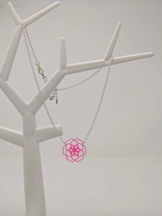 With a touch of silver and a splash of vibrant color, this necklace with 3D printed geometric flower pendant adds just the right wink of uniqueness to any look! (And just wait until you see it glow under blacklight!) This pendant necklace is printed with TPU filament, a flexible, translucent plastic, and printed on an Anet AM8 3D printer. The fine lines--each one less than a quarter of a millimeter thick--that make up each layer adds a dimension that makes them almost shimmer in light. And this 3d Printed Necklace Pendant, Hypoallergenic Pink Sterling Silver Necklace, Geometric Pink Jewelry For Gifts, Geometric Pink Jewelry For Gift, Pink Geometric Jewelry For Gifts, Pink Geometric Jewelry For Gift, Geometric Silver Necklace For Gift, Silver Geometric Necklace For Gift, Adjustable Geometric Necklace For Gifts