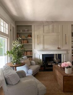 a living room filled with furniture and a fire place in the middle of a room