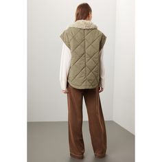 Green faux shearling (60% Polyethylene, 40% Cotton). Vest. Sleeveless. Collar. Front zipper closure. 27.5" from shoulder to hemline. Imported. Sleeveless Outerwear With Zipper Closure For Work, Sleeveless Fall Outerwear With Faux Fur Lining, Chic Sleeveless Outerwear With Faux Fur Trim, Sleeveless Outerwear With Faux Fur Lining For Fall, Sleeveless Outerwear With Faux Fur Trim For Fall, Fall Sleeveless Outerwear With Faux Fur Trim, Sleeveless Faux Fur Outerwear, Cotton Vest, Vanessa Bruno