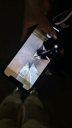 someone is holding their cell phone up to take a selfie with the image on it