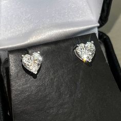 Stand out from the crowd with gorgeous heart cut studs! Moissanite offers timeless beauty and exceptional value. Our luxurious studs are GRA certified VVS1 clarity Moissanite hand set on high quality thick basket settings with screw-back posts. This is the best compromise between cheap fakes (CZ, crystal, rhinestone) and extremely expensive diamond studs. Natural diamond equivalent studs cost $10,000 - $100,000+. Get the same look at a reasonable price. Hundreds of 5 star reviews. Order your pair today! -VVS1 Clarity GRA certified Moissanite Stones -9.25 Hardness Rating. Diamonds are perfect 10, CZ is 3-4.  -Choose Rhodium (white) or Gold (yellow) finish 925 sterling silver -Passes many Thermal Diamond Testers -Comes with inner/outer box with certificate Expensive Diamond, Better Balance, Stud Design, Basket Setting, Solitaire Studs, Halo Earrings Studs, Diamond Watch, Gorgeous Earrings, 100 000