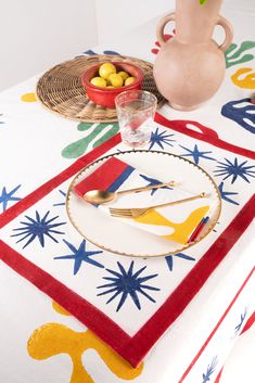 a table topped with a white plate covered in fruit